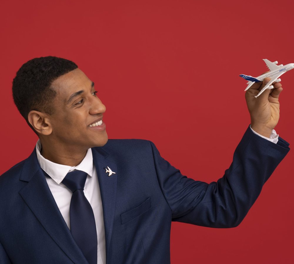 portrait-flight-attendant-with-plane-figurine